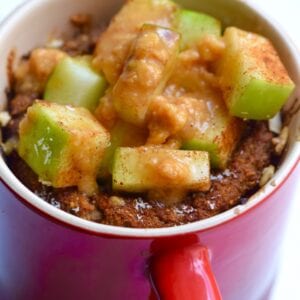 Vegan apple pie mug cake topped with extra chopped apples & caramel sauce