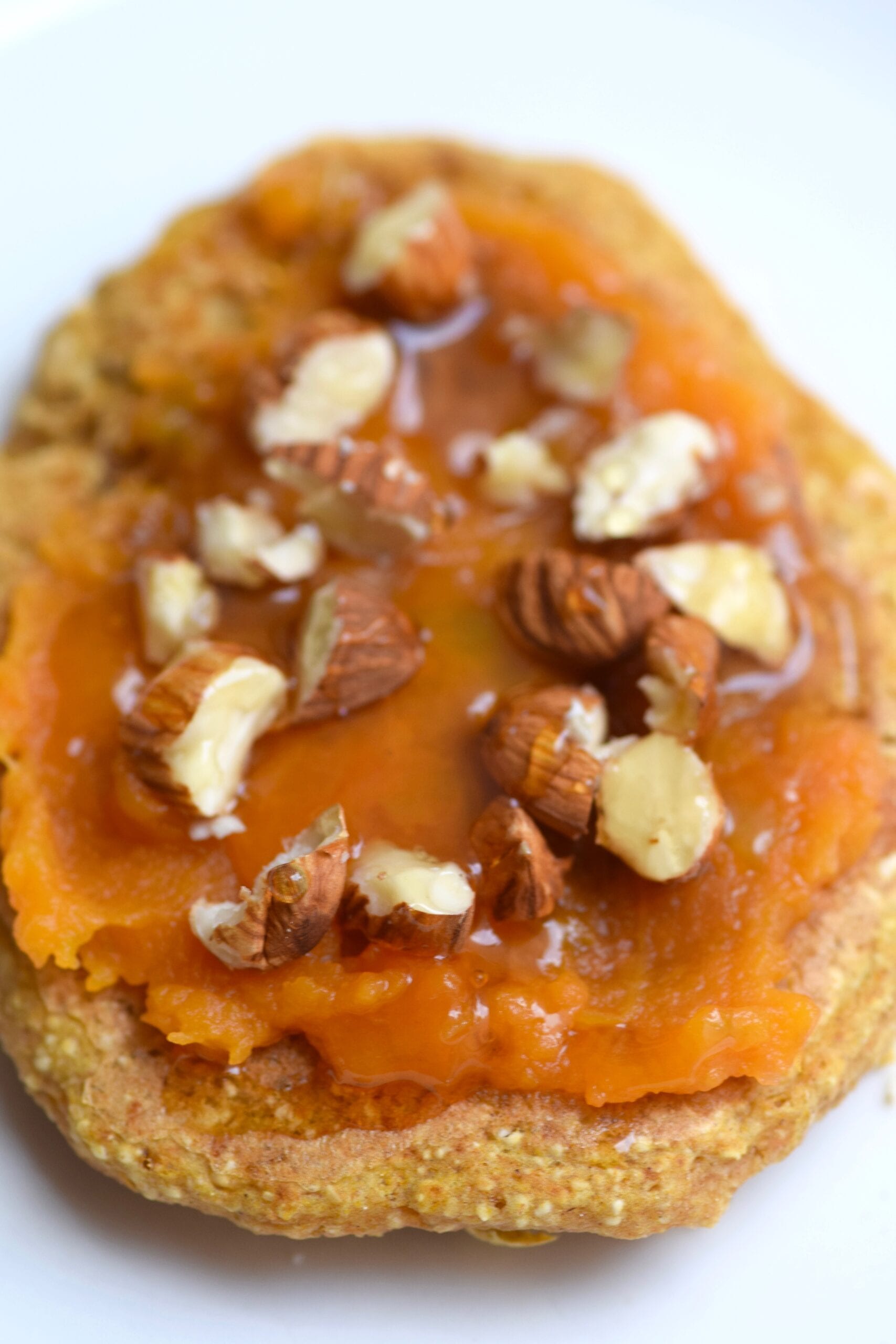 Pumpkin pancakes with pumpkin topping, crushed nuts and honey