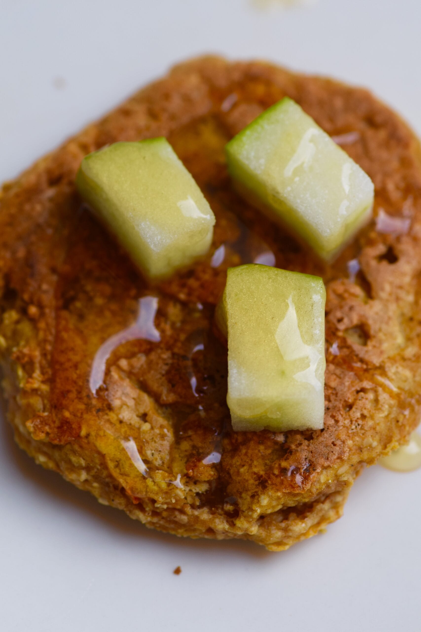 Pumpkin pancakes topped with apples and honey