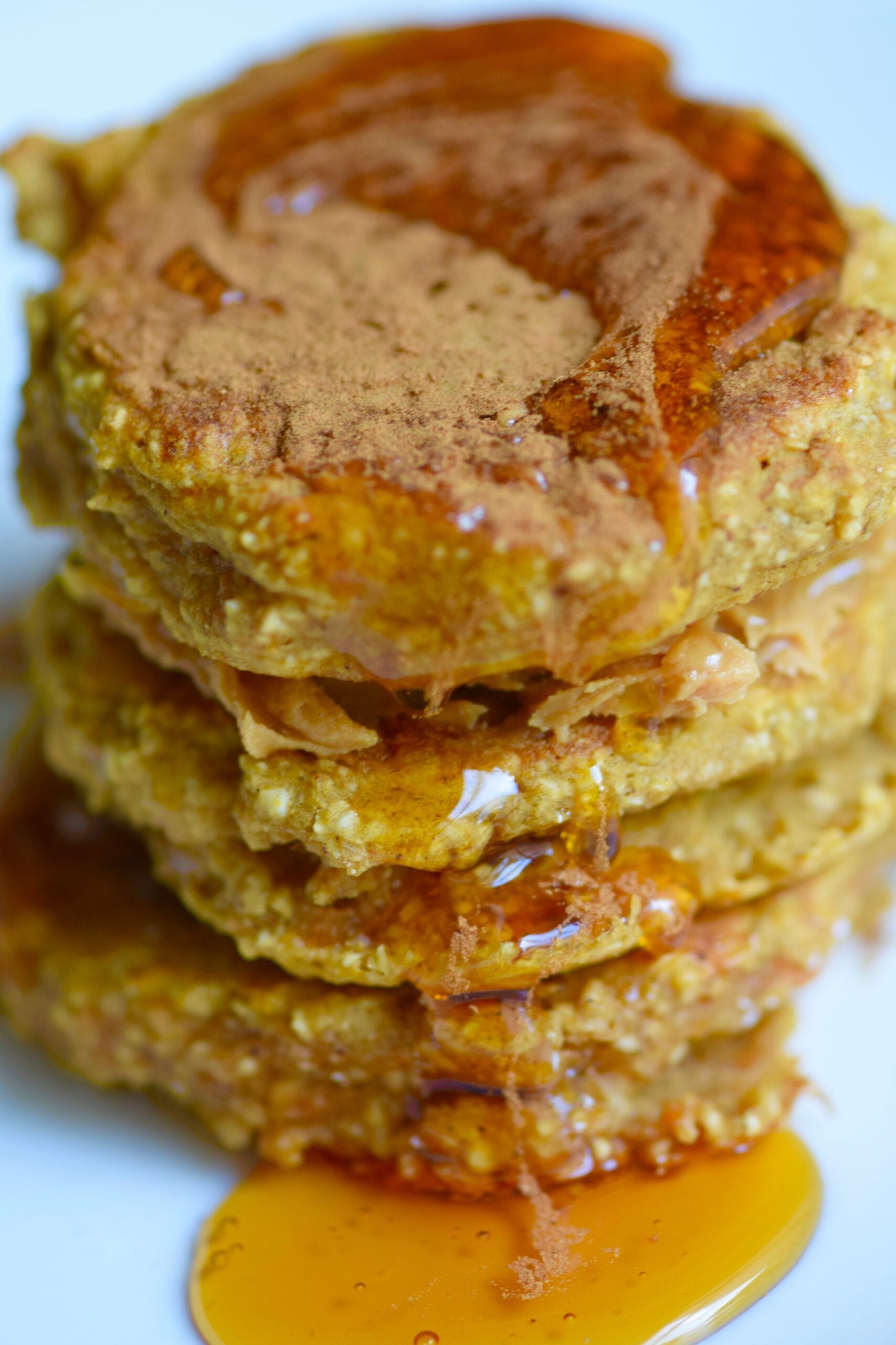 pumpkin pancake stack with syrup drizzled on-top