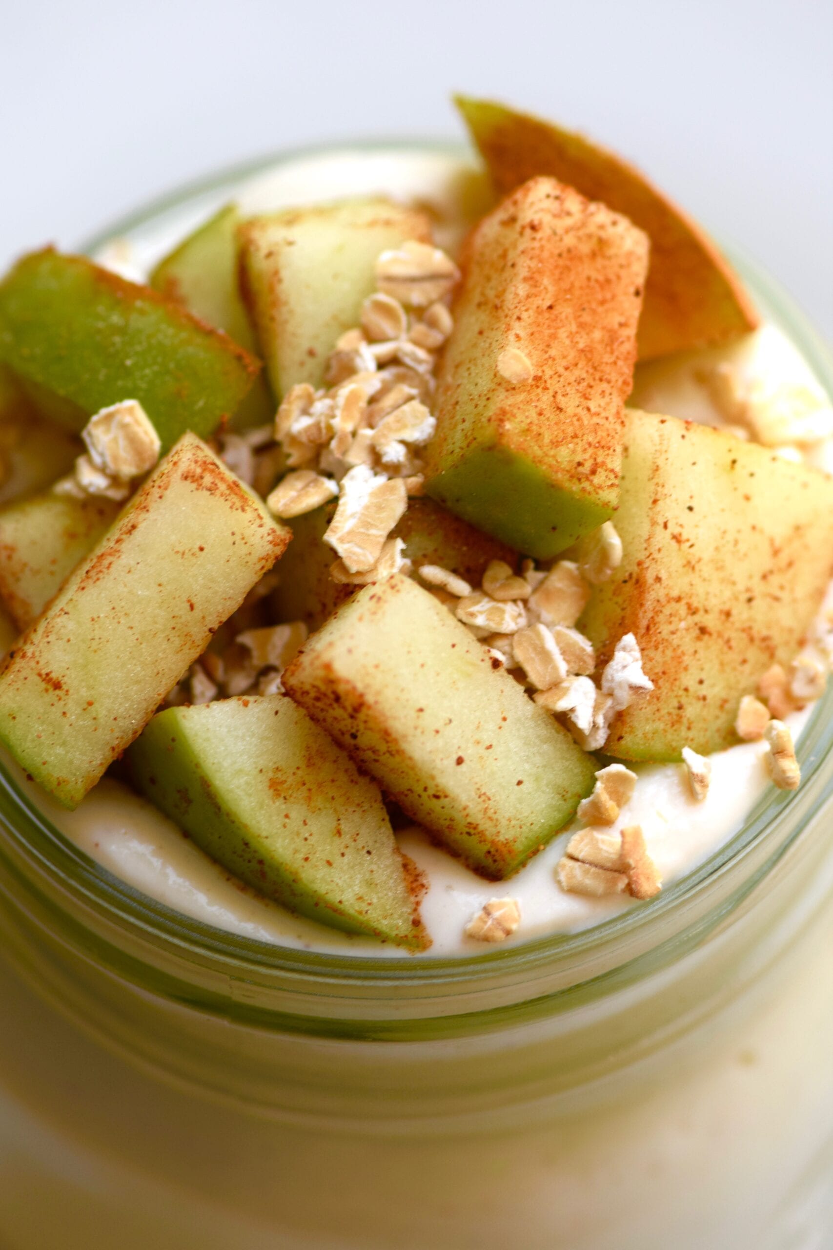 healthy apple pie cheesecake with chopped apples and granola topping