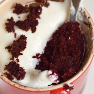 Healthy red velvet cupcake mug cake with spoon inside