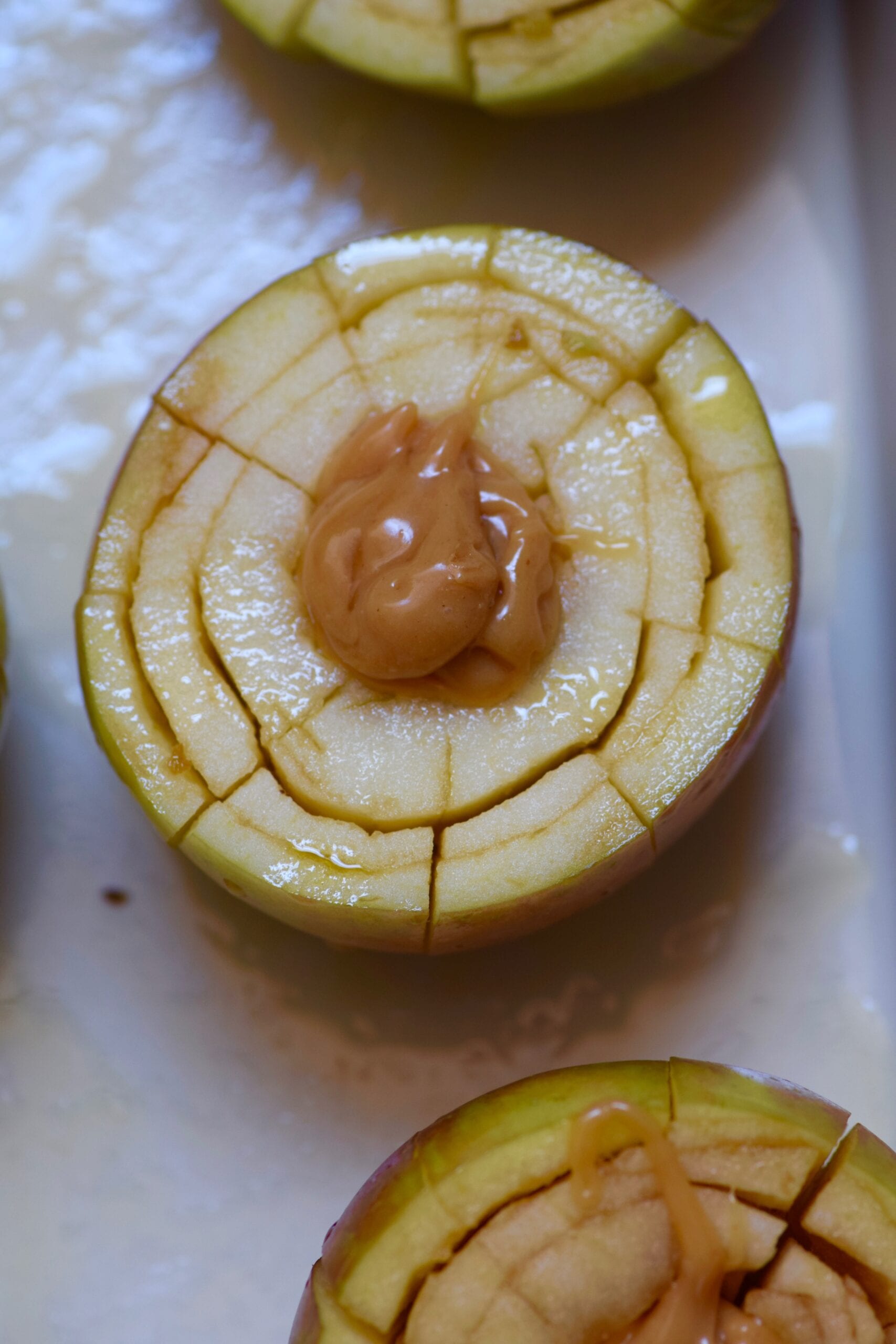 Filling each apple with caramel filling before baking