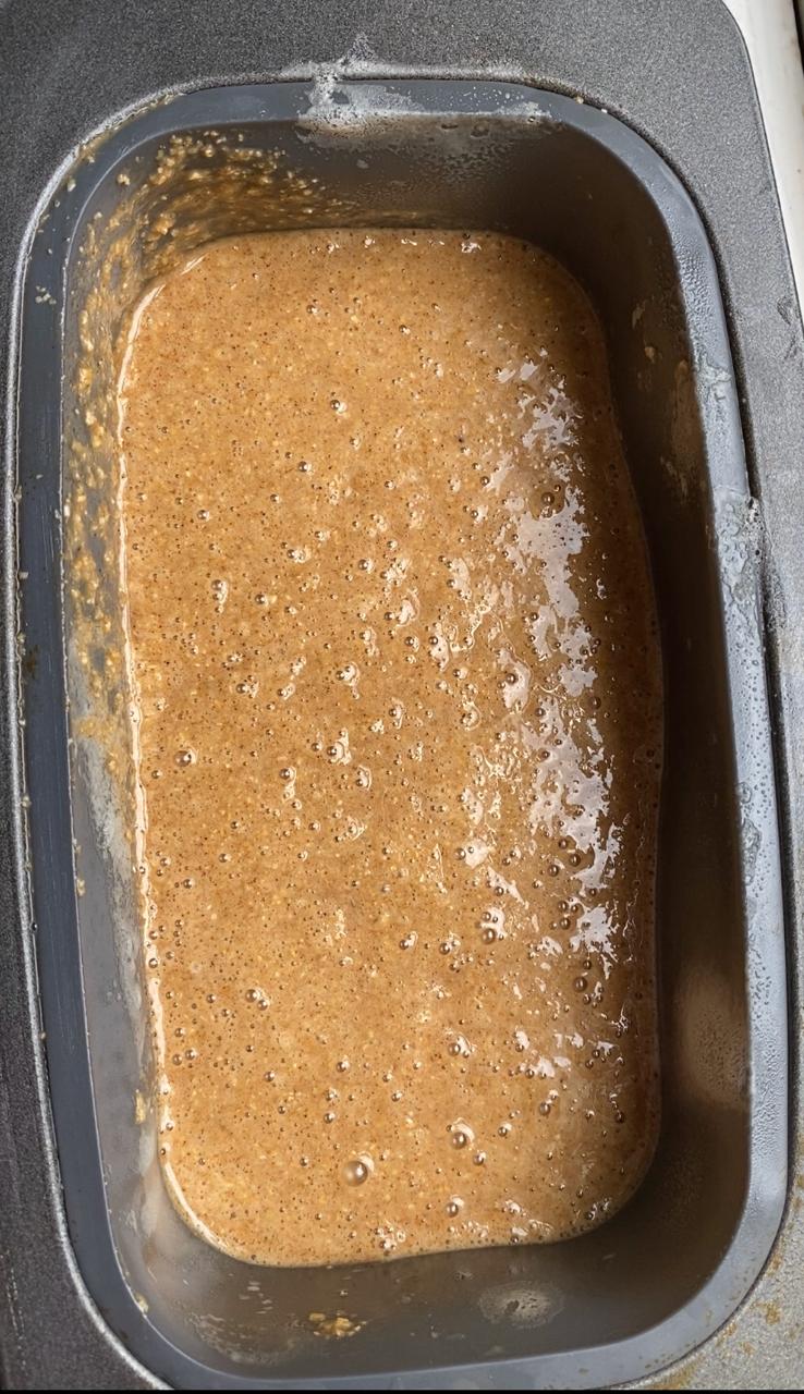 pouring the gingerbread batter into the loaf tin