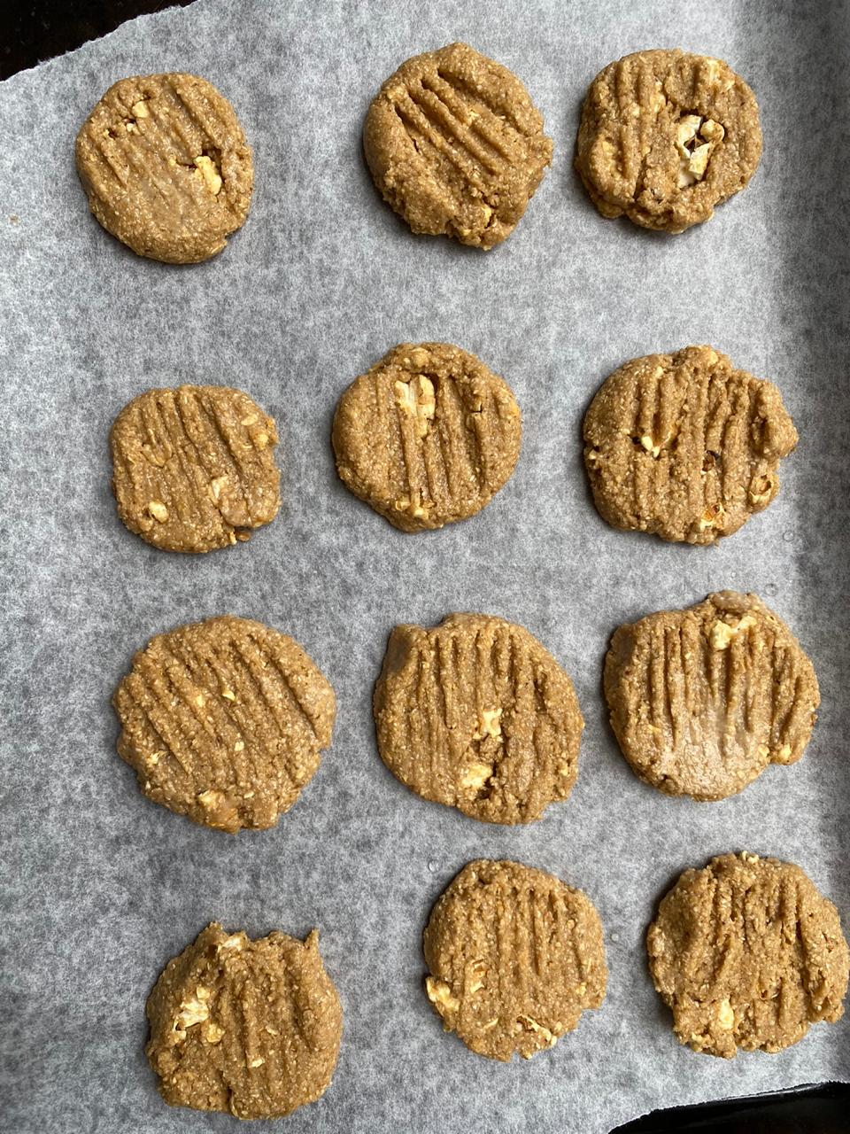 pressing down the easy christmas cookies with a fork