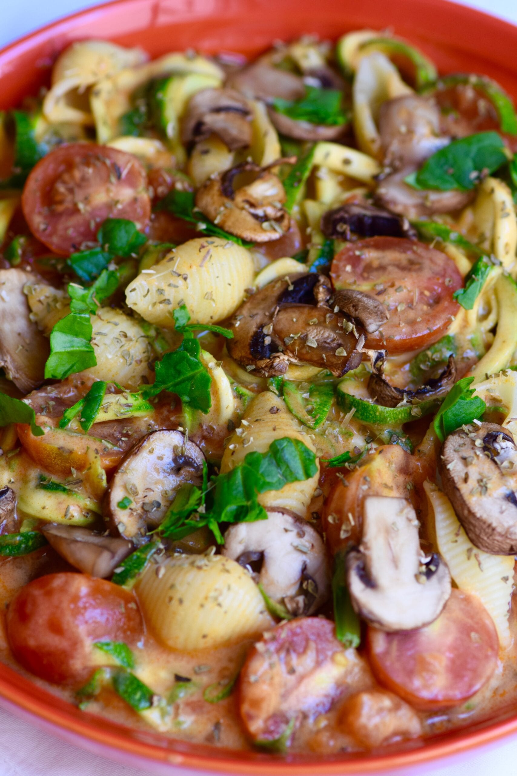 Low carb creamy tomato pasta with mushrooms, zucchini, tomatoes and basil