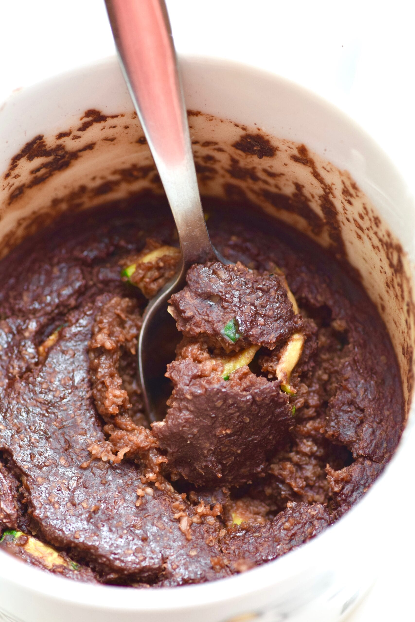 Zucchini brownie mug cake with spoon scooping it out
