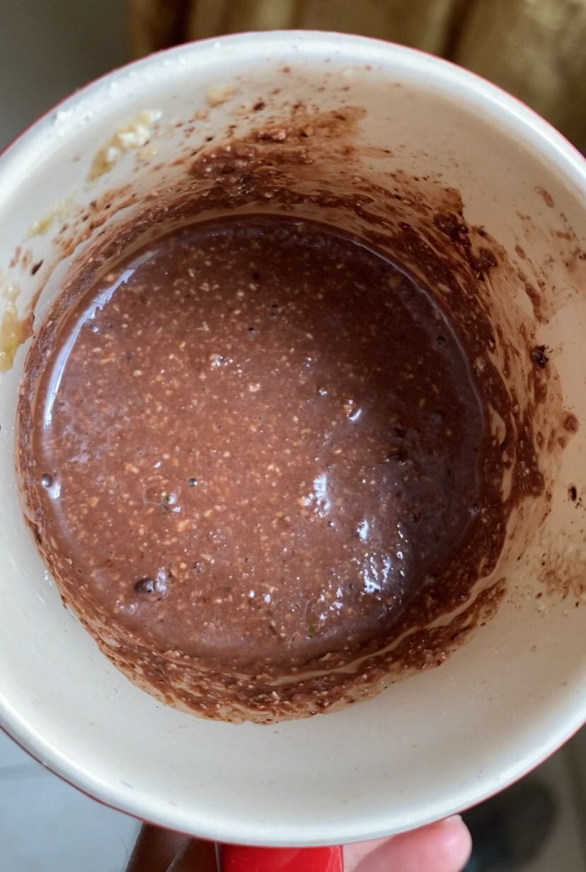 Mixing batter for chocolate zucchini vegan mug cake 