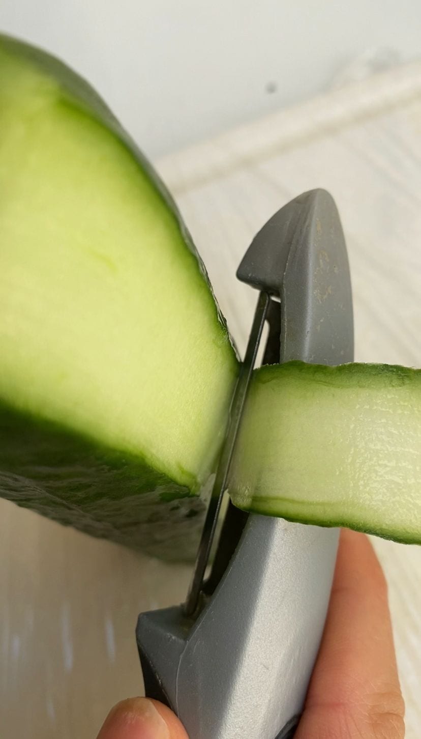 Using a veg peeler to make cucumber ribbons for the cucumber sushi rolls