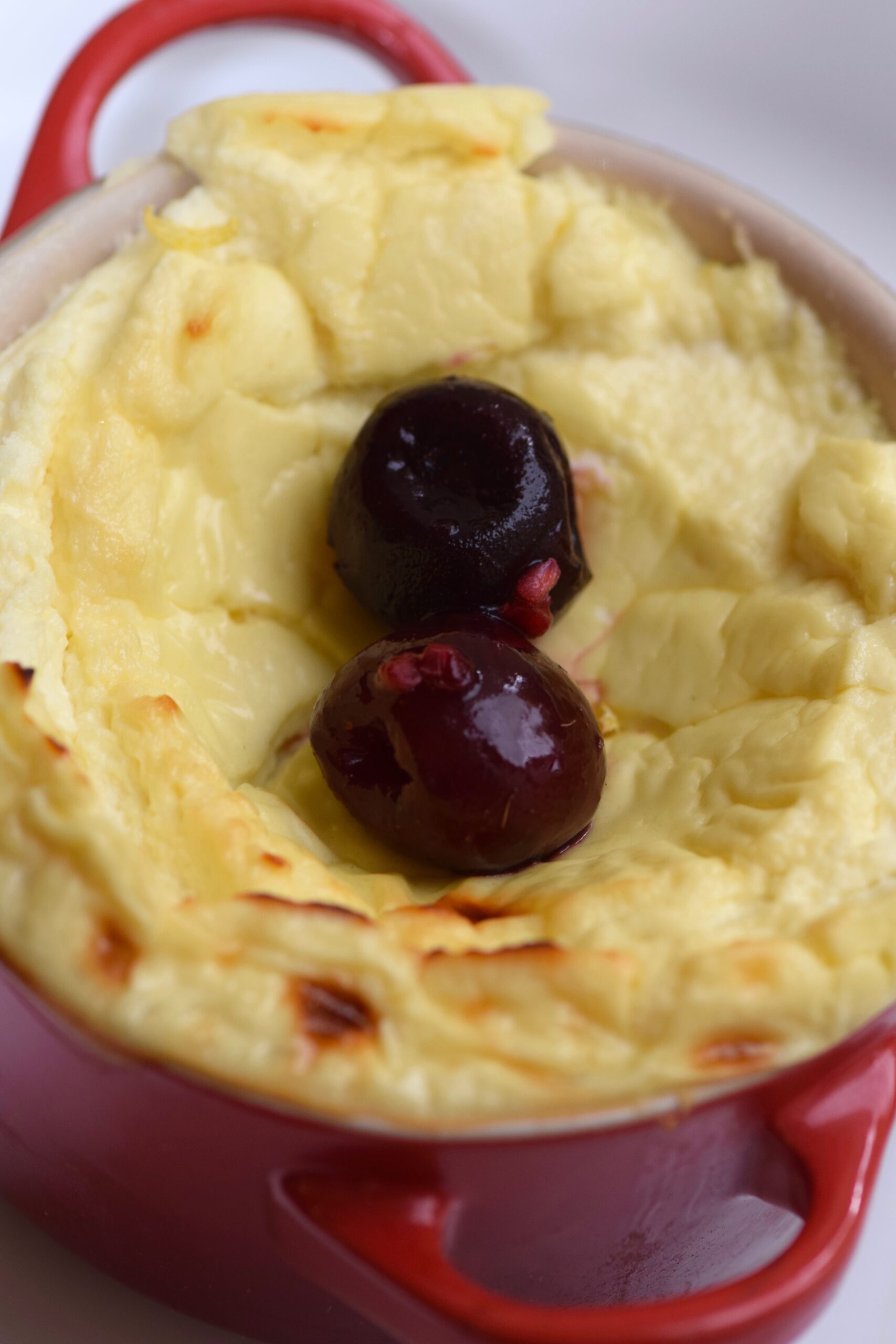 5 Minute Protein Cheesecake In a Mug with cherries