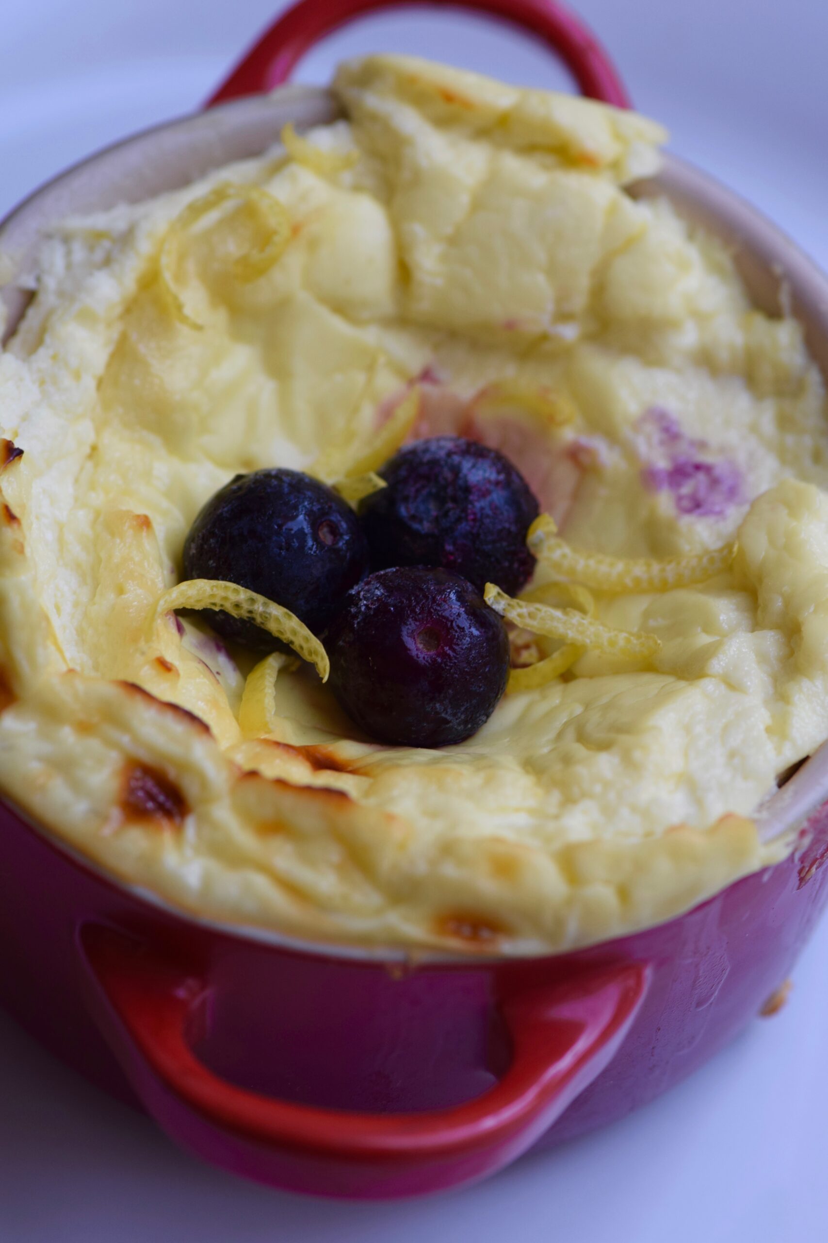 5 Minute Protein Cheesecake In a Mug with lemon and blueberries