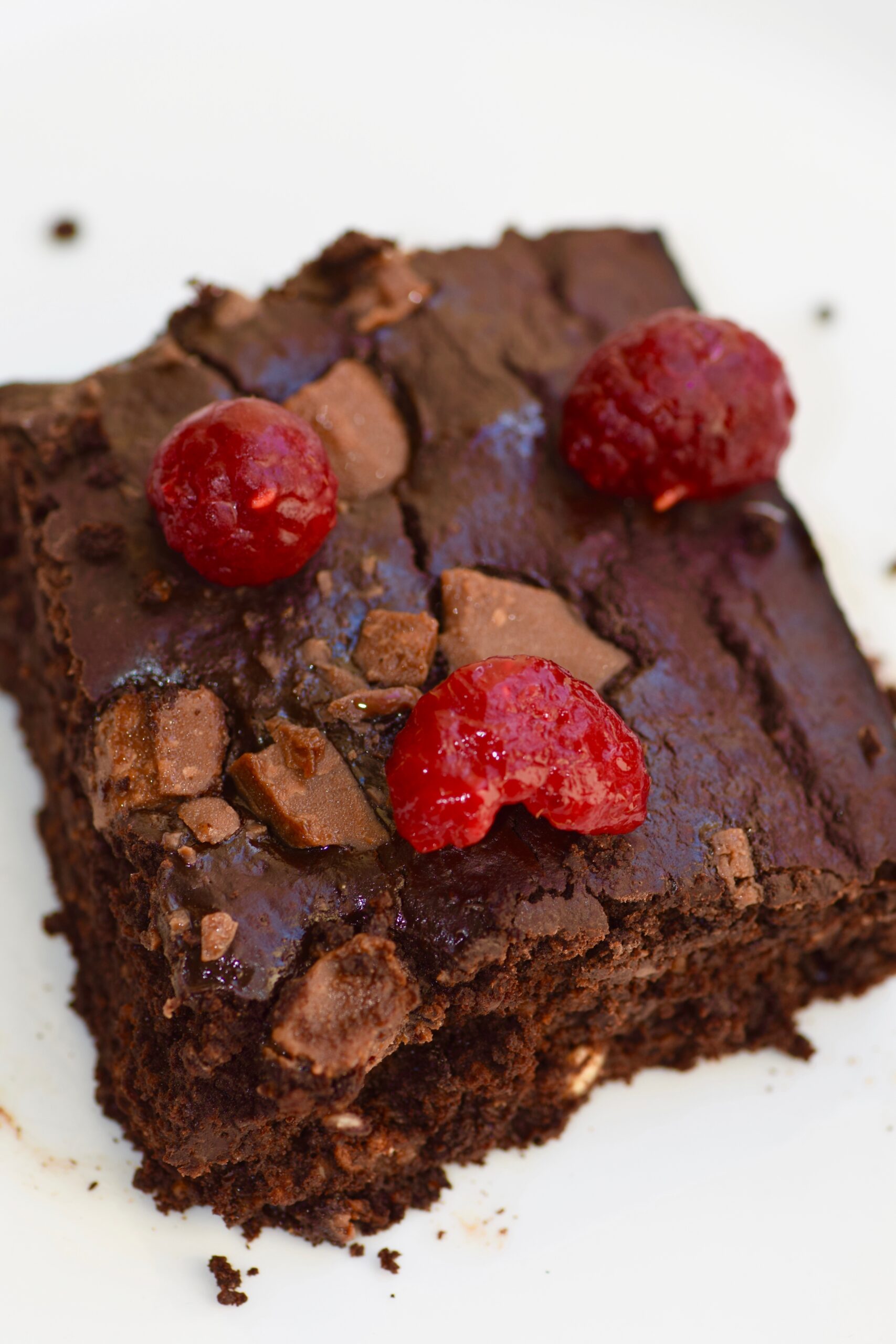 Healthy fudgy pumpkin brownies with raspberries