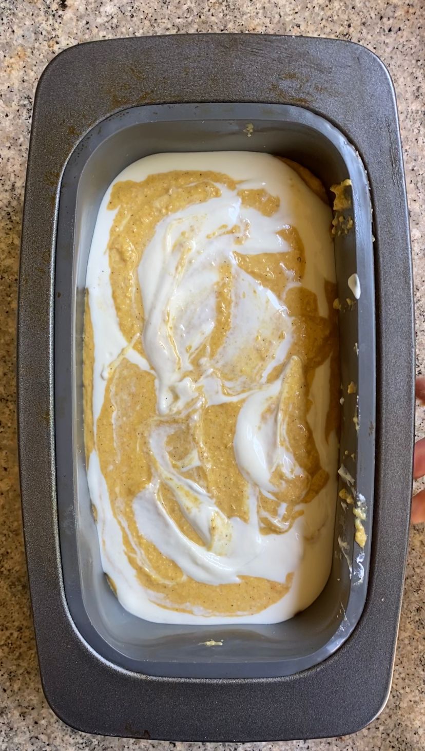 Mixing pumpkin cheesecake loaf in tin