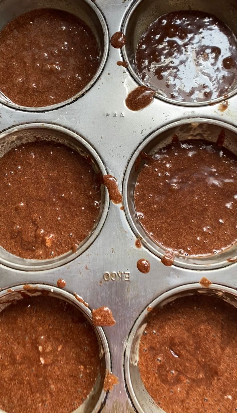 Pouring mixture into muffin trays